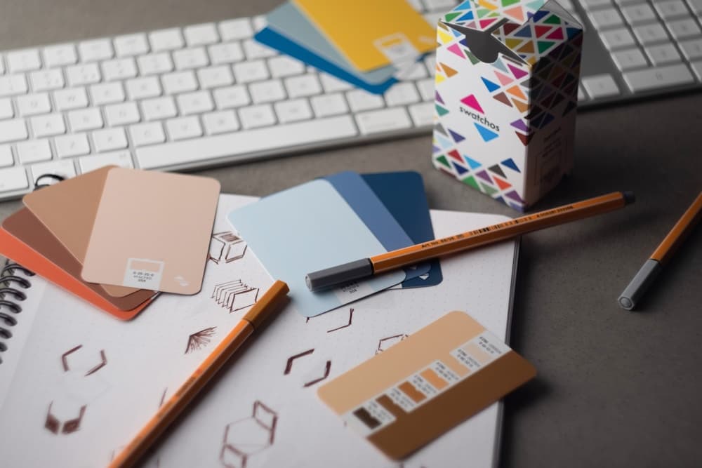 Color swatches and design sketches on a designer's desk